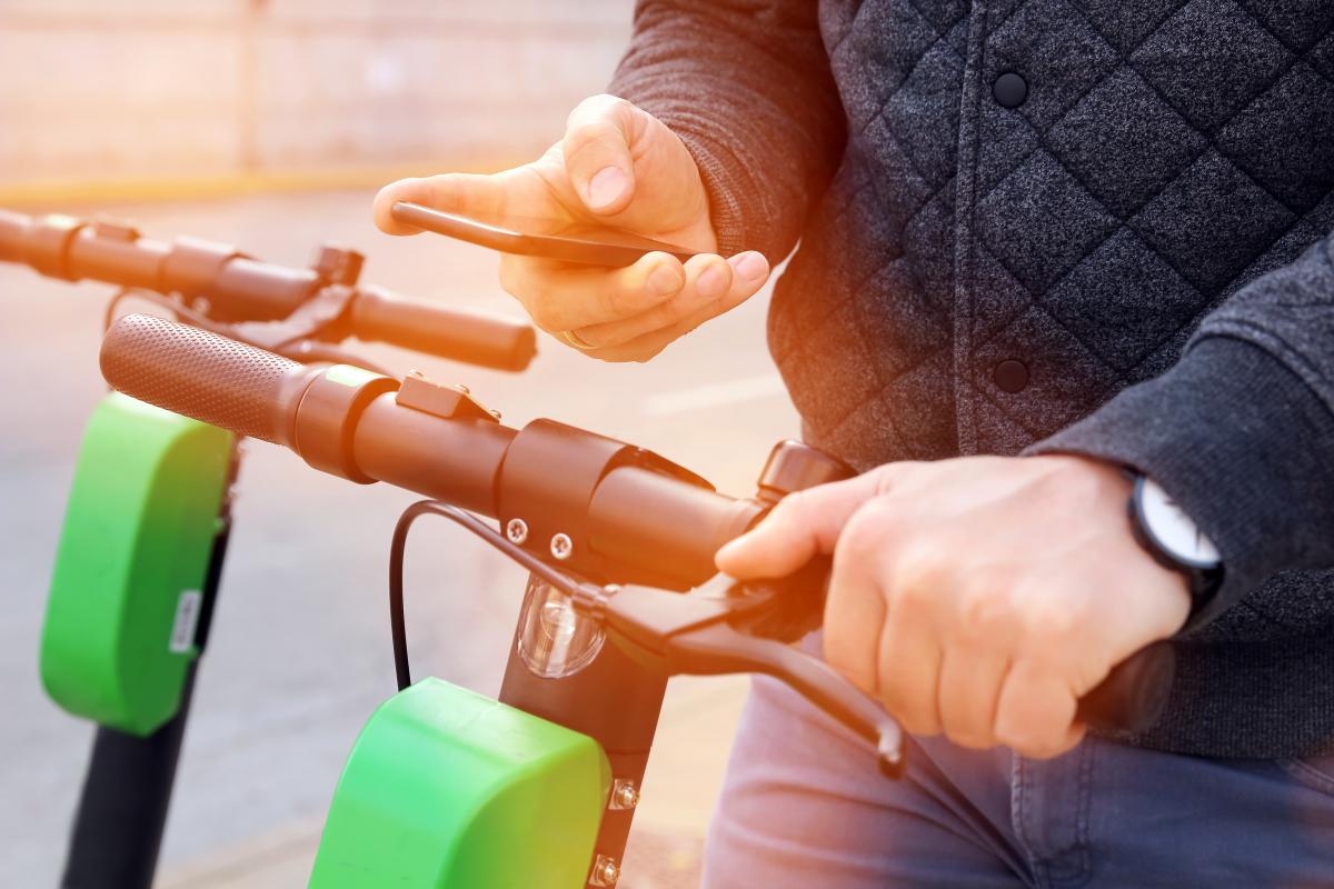 Man purchasing electric scooter with app