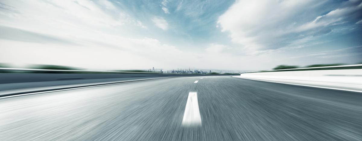 Panoramic view of road with blurs to indicate speed