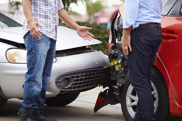 two men talking after a car accident 