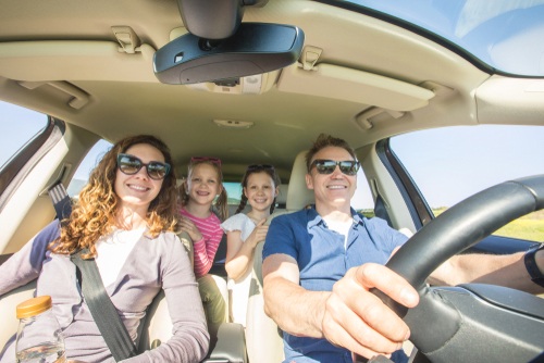 family with children is traveling in a car on a journey.